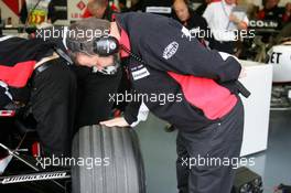 08.07.2005 Silverstone, England, Paul Stoddart (AUS), Team Principal Minardi F1 Team, personally checking the Bridgestone tyres on the car of Christijan Albers (NED), Minardi Cosworth - July, Formula 1 World Championship, Rd 11, British Grand Prix, Silverstone, England, Practice