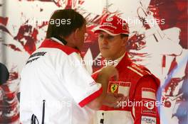 08.07.2005 Silverstone, England, Michael Schumacher (GER), Scuderia Ferrari Marlboro, Portrait, listening to Kees van de Grint (NED), Bridgestone Tyre Engineer - July, Formula 1 World Championship, Rd 11, British Grand Prix, Silverstone, England, Practice