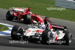 10.07.2005 Silverstone, England, Jenson Button, GBR, Lucky Strike BAR Honda 007, Action, Track leads Rubens Barrichello, BRA, Scuderia Ferrari Marlboro, F2005, Action, Track - July, Formula 1 World Championship, Rd 11, British Grand Prix, Silverstone, England, Race