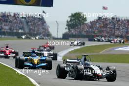 10.07.2005 Silverstone, England, Juan-Pablo Montoya, COL, West McLaren Mercedes leads the field on the first lap - July, Formula 1 World Championship, Rd 11, British Grand Prix, Silverstone, England, Race