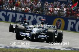 10.07.2005 Silverstone, England, Mark Webber, AUS, BMW WilliamsF1 Team, FW27, Action, Track leads Patrick Friesacher, AUT, Minardi Cosworth, Action, Track - July, Formula 1 World Championship, Rd 11, British Grand Prix, Silverstone, England, Race