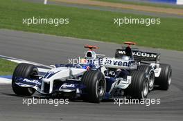 10.07.2005 Silverstone, England, Mark Webber, AUS, BMW WilliamsF1 Team, FW27, Action, Track leads Patrick Friesacher, AUT, Minardi Cosworth, Action, Track - July, Formula 1 World Championship, Rd 11, British Grand Prix, Silverstone, England, Race