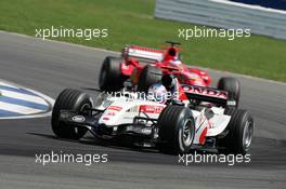 10.07.2005 Silverstone, England, Jenson Button, GBR, Lucky Strike BAR Honda 007, Action, Track leads Rubens Barrichello, BRA, Scuderia Ferrari Marlboro, F2005, Action, Track - July, Formula 1 World Championship, Rd 11, British Grand Prix, Silverstone, England, Race