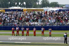 10.07.2005 Silverstone, England, Marshalls and the general public hold one minute of silence to remember the death from last Thursday's bomming in London - July, Formula 1 World Championship, Rd 11, British Grand Prix, Silverstone, England