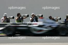 29.07.2005 Hungaroring, Hungary, Photographers working while Kimi Raikkonen (FIN), West McLaren Mercedes MP4-20, passes by - July, Formula 1 World Championship, Rd 13, Hungarian Grand Prix, Budapest, Hungary, HUN, Practice