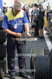 29.07.2005 Hungaroring, Hungary, A Michelin engineer testing the depth of the groves in the tyres - July, Formula 1 World Championship, Rd 13, Hungarian Grand Prix, Budapest, Hungary, HUN