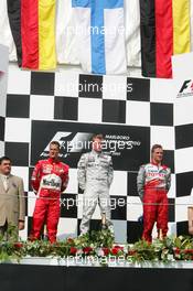 31.07.2005 Hungaroring, Hungary, Kimi Raikkonen (FIN), West McLaren Mercedes, Portrait (1st, center), Michael Schumacher (GER), Scuderia Ferrari Marlboro, Portrait (2nd, left) and Ralf Schumacher (GER), Panasonic Toyota Racing, Portrait (3rd, right) - July, Formula 1 World Championship, Rd 13, Hungarian Grand Prix, Budapest, Hungary, HUN, Podium