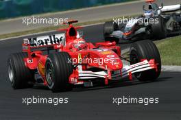 31.07.2005 Hungaroring, Hungary, Michael Schumacher (GER), Scuderia Ferrari Marlboro F2005, leads Kimi Raikkonen (FIN), West McLaren Mercedes MP4-20 - July, Formula 1 World Championship, Rd 13, Hungarian Grand Prix, Budapest, Hungary, HUN, Race