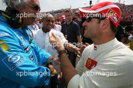 31.07.2005 Hungaroring, Hungary, Flavio Briatore (ITA), Managing Director Renault F1 Team, joking with Rubens Barrichello (BRA), Scuderia Ferrari Marlboro, Portrait - July, Formula 1 World Championship, Rd 13, Hungarian Grand Prix, Budapest, Hungary, HUN, Grid