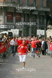 01.09.2005 Monza, Italy, "Vodafone Race" event Rubens Barrichello, BRA, Ferrari beating Michael Schumacher, GER, Ferrari, in a basketball runing race  Milan - September, Formula 1 World Championship, Rd 15, Italian Grand Prix