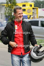 01.09.2005 Monza, Italy, Michael Schumacher, GER, Ferrari arrives at the track on a Ducati motorbike - September, Formula 1 World Championship, Rd 15, Italian Grand Prix