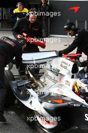 14.12.2005 Jerez, Spain,  Pedro de la Rosa (ESP), Test Driver, McLaren Mercedes is pulled back into the garage with mechanics watching with fire extinguishers - Formula One Testing, Jerez de la Frontera