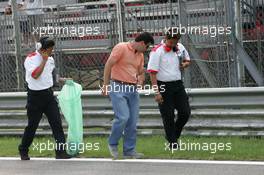25.08.2005 Monza, Italy, Bridgetone engineers searching for parts of the bursted left back tyre of Luca Badoer, ITA, Test Driver, Scuderia Ferrari - August, F1 testing, Autodromo Nazionale Monza, Italy