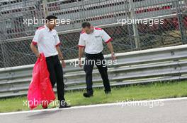 25.08.2005 Monza, Italy, Bridgetone engineers searching for parts of the bursted left back tyre of Luca Badoer, ITA, Test Driver, Scuderia Ferrari - August, F1 testing, Autodromo Nazionale Monza, Italy