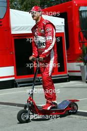 22.04.2005 Imola, San Marino, Michael Schumacher, GER, Ferrari on a electro scooter - April, Formula 1 World Championship, Rd 4, San Marino Grand Prix, RSM