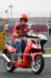 18.08.2005 Istanbul, Turkey, Michael Schumacher, GER, Ferrari views the circuit on a moped - August, Formula 1 World Championship, Rd 14, Turkish Grand Prix, Istanbul Park, Turkey