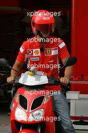 18.08.2005 Istanbul, Turkey, Michael Schumacher, GER, Ferrari views the circuit on a moped - August, Formula 1 World Championship, Rd 14, Turkish Grand Prix, Istanbul Park, Turkey