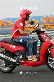 18.08.2005 Istanbul, Turkey, Michael Schumacher, GER, Ferrari views the circuit on a moped - August, Formula 1 World Championship, Rd 14, Turkish Grand Prix, Istanbul Park, Turkey