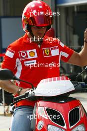 18.08.2005 Istanbul, Turkey, Michael Schumacher, GER, Ferrari views the circuit on a moped - August, Formula 1 World Championship, Rd 14, Turkish Grand Prix, Istanbul Park, Turkey