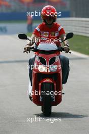 18.08.2005 Istanbul, Turkey, Michael Schumacher, GER, Ferrari views the circuit on a moped - August, Formula 1 World Championship, Rd 14, Turkish Grand Prix, Istanbul Park, Turkey