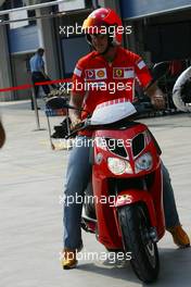 18.08.2005 Istanbul, Turkey, Michael Schumacher, GER, Ferrari views the circuit on a moped - August, Formula 1 World Championship, Rd 14, Turkish Grand Prix, Istanbul Park, Turkey