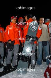 12.01.2005 Madonna di Campiglio, Italy, Michael Schumacher (GER), Scuderia Ferrari Marlboro, Portrait (right) and Luca Badoer (ITA), Test driver Scuderia Ferrari Marlboro, Portrait (left), having a go on a snow board of the FIAT Freestyle Team - Wrooom 2005, 15th annual Ski Press Meeting of Scuderia Ferrari Marlboro in Madonna di Campiglio, The Dolomites, Italy