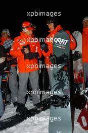 12.01.2005 Madonna di Campiglio, Italy, Michael Schumacher (GER), Scuderia Ferrari Marlboro, Portrait (right) and Luca Badoer (ITA), Test driver Scuderia Ferrari Marlboro, Portrait (left), having a go on a snow board of the FIAT Freestyle Team - Wrooom 2005, 15th annual Ski Press Meeting of Scuderia Ferrari Marlboro in Madonna di Campiglio, The Dolomites, Italy