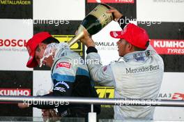 18.09.2005 Klettwitz, Germany,  Podium, Lewis Hamilton (GBR), ASM Formule 3, Dallara F305 Mercedes (1st, right), gives Adrian Sutil (GER), ASM Formule 3, Dallara F305 Mercedes (2nd, left), a champaign shower - F3 Euro Series 2005 at Lausitzring