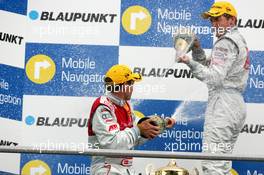 09.04.2006 Hockenheim, Germany,  Podium, Tom Kristensen (DNK), Audi Sport Team Abt Sportsline, Portrait (2nd, left) and Bernd Schneider (GER), AMG-Mercedes, Portrait (3rd, right), spraying with champaign - DTM 2006 at Hockenheimring (Deutsche Tourenwagen Masters)