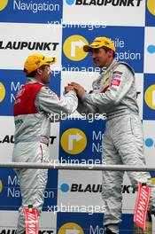 09.04.2006 Hockenheim, Germany,  Podium, Tom Kristensen (DNK), Audi Sport Team Abt Sportsline, Portrait (2nd, left), congratulates Bernd Schneider (GER), AMG-Mercedes, Portrait (1st, right), with his victory - DTM 2006 at Hockenheimring (Deutsche Tourenwagen Masters)