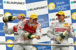 09.04.2006 Hockenheim, Germany,  Podium, champaign for Tom Kristensen (DNK), Audi Sport Team Abt Sportsline, Portrait (2nd, center), Bernd Schneider (GER), AMG-Mercedes, Portrait (1st, right) and Heinz-Harald Frentzen (GER), Audi Sport Team Abt Sportsline, Por trait(3rd, right) - DTM 2006 at Hockenheimring (Deutsche Tourenwagen Masters)