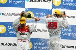 09.04.2006 Hockenheim, Germany,  Podium, Bernd Schneider (GER), AMG-Mercedes, Portrait (1st, right) and Heinz-Harald Frentzen (GER), Audi Sport Team Abt Sportsline, Portrait (3rd, left), spraying with champaign - DTM 2006 at Hockenheimring (Deutsche Tourenwagen Masters)