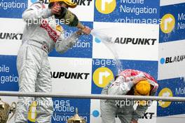 09.04.2006 Hockenheim, Germany,  Podium, Bernd Schneider (GER), AMG-Mercedes, Portrait (1st, left), gives Heinz-Harald Frentzen (GER), Audi Sport Team Abt Sportsline, Portrait (2nd, right), a champaign shower - DTM 2006 at Hockenheimring (Deutsche Tourenwagen Masters)