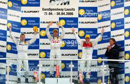 30.04.2006 Klettwitz, Germany,  Podium DTM for the before the mix up with the stage numbers! (left) Mika Häkkinen (FIN), AMG-Mercedes, AMG-Mercedes C-Klasse ( 3rd, but standing in positions of 2nd); Bernd Schneider (GER), AMG-Mercedes, AMG-Mercedes C-Klasse ; (right) Tom Kristensen (DNK), Audi Sport Team Abt Sportsline, Audi A4 DTM (2nd, but standing at the position of the 3rd place!). - DTM 2006 at Eurospeedway Lausitzring (Deutsche Tourenwagen Masters)