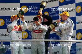 30.04.2006 Klettwitz, Germany,  Podium of the DTM drinking champagne. (left) Tom Kristensen (DNK), Audi Sport Team Abt Sportsline, Audi A4 DTM (2nd); (middle) Bernd Schneider (GER), AMG-Mercedes, AMG-Mercedes C-Klasse (1st); (background) Hans-Jürgen Mattheis (GER), Team Manager HWA; (right) Mika Häkkinen (FIN), AMG-Mercedes, AMG-Mercedes C-Klasse - DTM 2006 at Eurospeedway Lausitzring (Deutsche Tourenwagen Masters)