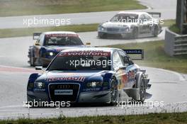 19.05.2006 Oschersleben, Germany,  Mattias Ekström (SWE), Audi Sport Team Abt Sportsline, Audi A4 DTM, leads Martin Tomczyk (GER), Audi Sport Team Abt Sportsline, Audi A4 DTM and Mika Häkkinen (FIN), AMG-Mercedes, AMG-Mercedes C-Klasse, out of the pit exit - DTM 2006 at Motorsport Arena Oschersleben (Deutsche Tourenwagen Masters)