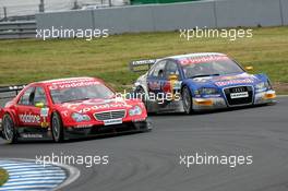 21.05.2006 Oschersleben, Germany,  Bernd Schneider (GER), AMG-Mercedes, AMG-Mercedes C-Klasse, judge edges in front of Martin Tomczyk (GER), Audi Sport Team Abt Sportsline, Audi A4 DTM when the latter comes out of the pits - DTM 2006 at Motorsport Arena Oschersleben (Deutsche Tourenwagen Masters)