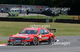 30.06.2006 Fawkham, England,  Bernd Schneider (GER), AMG-Mercedes, AMG-Mercedes C-Klasse passing the medical centre with the awaiting helicopter in front of it. - DTM 2006 at Brands Hatch, England (Deutsche Tourenwagen Masters)