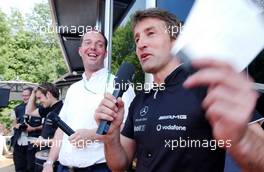 01.07.2006 Fawkham, England,  Bernd Schneider (GER), AMG-Mercedes, AMG-Mercedes C-Klasse having a joke with the audience during the public pressconference at Saturday. To the left the Dutch commentator René de Boer. - DTM 2006 at Brands Hatch, England (Deutsche Tourenwagen Masters)