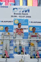 02.07.2006 Fawkham, England,  Podium, Mattias Ekström (SWE), Audi Sport Team Abt Sportsline, Portrait (1st, center), Jamie Green (GBR), AMG-Mercedes, Portrait (2nd, left) and Bernd Schneider (GER), AMG-Mercedes, Portrait (3rd, right) - DTM 2006 at Brands Hatch, England (Deutsche Tourenwagen Masters)