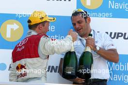 02.07.2006 Fawkham, England,  Podium, Mattias Ekström (SWE), Audi Sport Team Abt Sportsline, Portrait (1st, left) and Hans-Jurgen Abt (GER), Teamchef Abt-Audi (right), toasting on the victory - DTM 2006 at Brands Hatch, England (Deutsche Tourenwagen Masters)