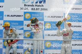 02.07.2006 Fawkham, England,  Podium, Mattias Ekström (SWE), Audi Sport Team Abt Sportsline, Portrait (1st, center), Jamie Green (GBR), AMG-Mercedes, Portrait (2nd, left) and Bernd Schneider (GER), AMG-Mercedes, Portrait (3rd, right), spraying champaign - DTM 2006 at Brands Hatch, England (Deutsche Tourenwagen Masters)