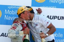 02.07.2006 Fawkham, England,  Podium, Mattias Ekström (SWE), Audi Sport Team Abt Sportsline, Portrait (1st, left), being congratulates by Hans-Jurgen Abt (GER), Teamchef Abt-Audi - DTM 2006 at Brands Hatch, England (Deutsche Tourenwagen Masters)