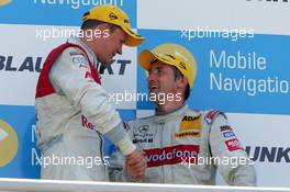 02.07.2006 Fawkham, England,  Podium, Mattias Ekström (SWE), Audi Sport Team Abt Sportsline, Portrait (1st, left), congratulates Bernd Schneider (GER), AMG-Mercedes, Portrait (2nd, right) - DTM 2006 at Brands Hatch, England (Deutsche Tourenwagen Masters)