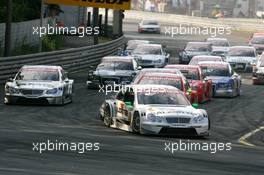 23.07.2006 Nurnberg, Germany,  Start of the race, with Jamie Green (GBR), AMG-Mercedes, AMG-Mercedes C-Klasse, leading the field into the first corner - DTM 2006 at Norisring (Deutsche Tourenwagen Masters)