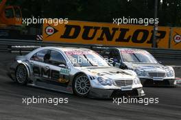 23.07.2006 Nurnberg, Germany,  Mika Häkkinen (FIN), AMG-Mercedes, AMG-Mercedes C-Klasse and Bruno Spengler (CDN), AMG-Mercedes, AMG-Mercedes C-Klasse, fighting for position - DTM 2006 at Norisring (Deutsche Tourenwagen Masters)