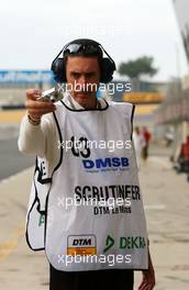 13.10.2006 Le Mans, France,  French scrutineer more concerned with his own private camera instead of technical affairs and regulations. - DTM 2006 at Le Mans Bugatti Circuit, France (Deutsche Tourenwagen Masters)