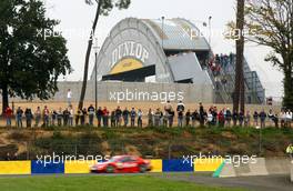 14.10.2006 Le Mans, France,  General view of the crowd watching the DTM at Le Mans. Jean Alesi (FRA), Persson Motorsport AMG-Mercedes, AMG-Mercedes C-Klasse is driving by and in the background the world famous Dunlop bridge is visible. - DTM 2006 at Le Mans Bugatti Circuit, France (Deutsche Tourenwagen Masters)