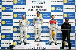 15.10.2006 Le Mans, France,  Podium, Bruno Spengler (CDN), AMG-Mercedes, Portrait (1st, center), Mika Häkkinen (FIN), AMG-Mercedes, Portrait (2nd, left) and Tom Kristensen (DNK), Audi Sport Team Abt Sportsline, Portrait (3rd, right). Far right: Gerhard Ungar (GER), Chief Designer AMG - DTM 2006 at Le Mans Bugatti Circuit, France (Deutsche Tourenwagen Masters)