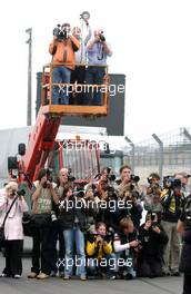 15.10.2006 Le Mans, France,  At the end of the afternoon Mercedes Benz organised a special media photocall with Bernd Schneider (GER), AMG-Mercedes, AMG-Mercedes C-Klasse and his team in the straight. Here visible the media attention for the shoot. Up in the air is the official Mercedes photograher. - DTM 2006 at Le Mans Bugatti Circuit, France (Deutsche Tourenwagen Masters)